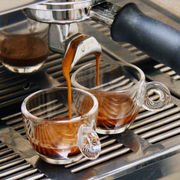 Espresso brewing, with a dark reddish-brown foam, called crema